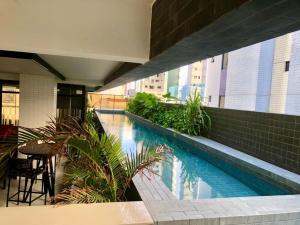 a swimming pool in the middle of a building at Co-House Tambaú in Tambaú