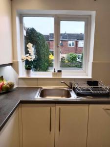 a kitchen with a sink and a window at Monmouth Aylesbury Retreat in Buckinghamshire