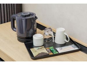 a tray with a coffee pot and cups on a table at Soma Station Hotel - Vacation STAY 40250v in Soma