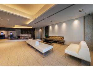 a lobby with white furniture and a fireplace at Soma Station Hotel - Vacation STAY 40262v in Soma