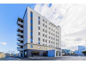 a large white building with blue windows at Soma Station Hotel - Vacation STAY 40262v in Soma