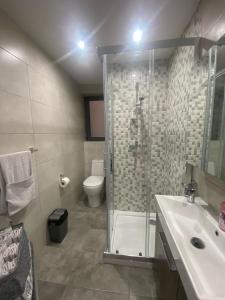 ein Bad mit einer Dusche, einem WC und einem Waschbecken in der Unterkunft Brand New 2 Bedroom Apartment in Tal-Pietà