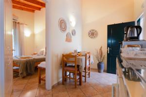 a kitchen and dining room with a table and chairs at Almyra Apartments & Studios in Agios Gordios