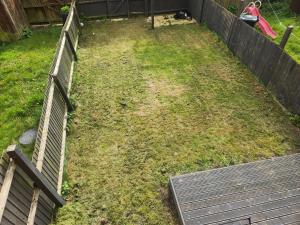 an empty backyard with a fence and grass at Sixty Nines in Dallington