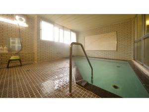 a room with a swimming pool in a building at Hotel Takimoto - Vacation STAY 43492v in Yamanouchi