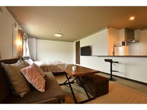 a living room with a couch and a table at Hotel Takimoto - Vacation STAY 43488v in Yamanouchi
