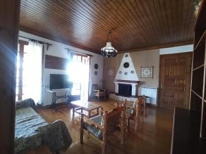 a living room with a fireplace and a couch at Seaside Selana Home in Nikiana