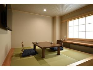 a room with a table and chairs and a window at Hotel Takimoto - Vacation STAY 43490v in Yamanouchi