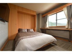 Łóżko lub łóżka w pokoju w obiekcie Hotel Takimoto - Vacation STAY 43491v