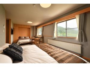 Łóżko lub łóżka w pokoju w obiekcie Hotel Takimoto - Vacation STAY 43491v