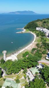 an aerial view of a beach and the ocean at Loft Sahy - Condado Aldeia dos Reis in Mangaratiba