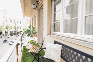 an apartment balcony with a bench and a window at Monastiraki Luxury Loft in Athens