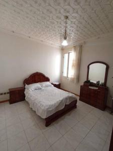 - une chambre avec un lit et un miroir dans l'établissement Apartment in Larache center, à Larache