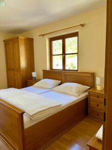 a bedroom with a large bed and a window at Hotel Alpine in Log pod Mangartom