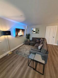 a living room with a couch and a table at New 3 bedroom apartment by the beach Belmullet. in Belmullet