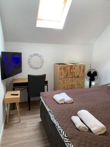 a bedroom with a bed and a desk and a television at Dark Horse Apartament in Chojnice +12 photos