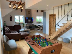 a living room with a foosball table at Dark Horse Apartament in Chojnice +12 photos
