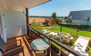 a balcony with a view of a garden at Wellnesshotel Hohenrodt in Loßburg