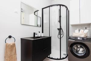 a bathroom with a sink and a washing machine at A Riduli in Split +37 photos