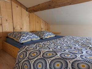 a bedroom with a bed and two pillows on it at Studio meublé proche conseil départemental du Jura in Lons-le-Saunier