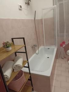 a bathroom with a shower and a bath tub with a shower at Vittoria House in Sciacca