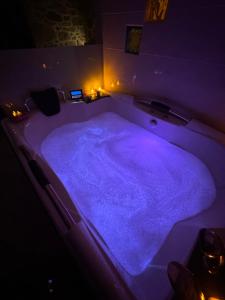 a large bath tub with purple lighting in a room at La casita de los Arribes in Fermoselle