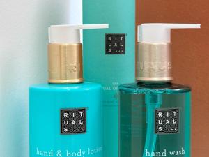 two bottles of hand and body lotion sitting next to each other at Les suites du 13 in Aigues-Mortes