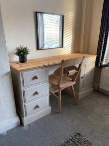 a desk with a chair and a mirror at Rustic Retreat cottage in Thirsk