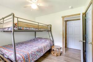 a bedroom with a bunk bed and a ceiling fan at Cottage with Yard and Grill about 21 Mi to Hocking Hills! in Nelsonville