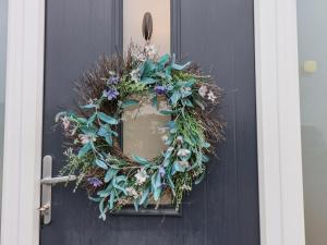 a black door with a wreath on it at Castle View in Scarborough