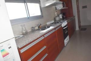 a kitchen with a sink and a stove at San Isidro in Viedma