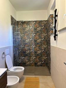 a bathroom with a toilet and a glass shower at La Casetta in Varese Ligure