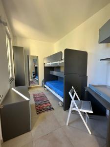 a room with two bunk beds and a desk at La Casetta in Varese Ligure