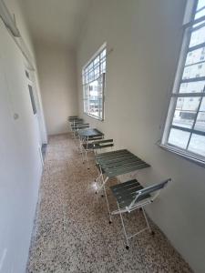 a row of chairs in a room with a window at Residencial Ideal in Lisbon