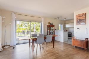 a kitchen and dining room with a table and chairs at Beautiful T3 with large terrace - Anglet - Welkeys in Anglet