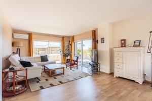 a living room with a couch and a table at Beautiful T3 with large terrace - Anglet - Welkeys in Anglet