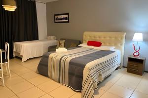 Postel nebo postele na pokoji v ubytování VA Apart Hotel Savassi