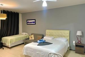 Postel nebo postele na pokoji v ubytování VA Apart Hotel Savassi