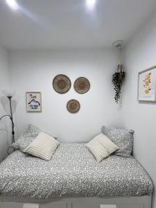 a room with a bed and three plates on the wall at Cosy Studio *Vieux-Port* in Marseille