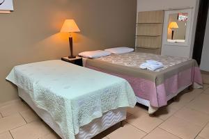 Postel nebo postele na pokoji v ubytování VA Apart Hotel Savassi
