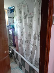 a bathroom with a shower curtain with a spiderweb at Kalys House in Kavála +8 photos