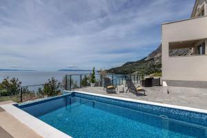 a swimming pool with a view of the ocean at Villa No stress in Drasnice