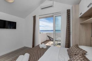 a bedroom with a bed with a view of the ocean at Villa No stress in Drasnice +54 photos