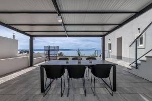 a table and chairs on a balcony with a view at Villa No stress in Drasnice