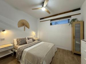 a bedroom with a bed and a ceiling fan at Private pool, parking, BBQ in the South of GC in Las Palmas de Gran Canaria +25 photos
