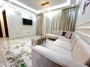 a living room with a couch and a tv at Property Sisters, Elite apartment, B11 in Madinaty
