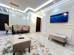 a living room with a table and a tv on a wall at Property Sisters, Elite apartment, B11 in Madinaty +10 photos