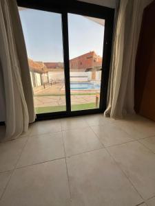 a room with a large window and a tiled floor at DownTown Hotel in Dahab