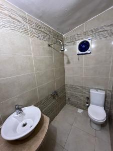 a bathroom with a toilet and a sink at DownTown Hotel in Dahab