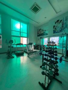 a gym with a bunch of equipment in a room at Apartamento ITAIGARA in Salvador